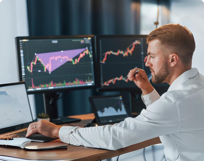 Man trading with multiple screens